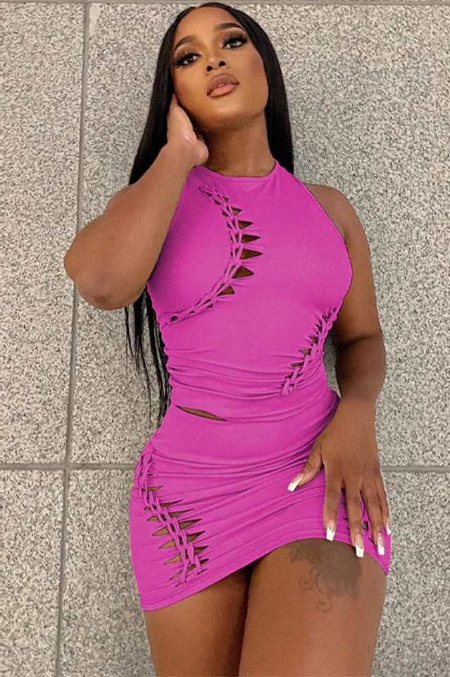 Woman modeling a vibrant pink knit bodycon dress with cut-out and lace-up details