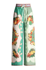 Front view of wide-leg fruit print pajama pants with a polka dot pattern and drawstring waist.