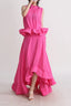 Woman in a bright pink two-piece set, showing the tiered ruffles on the skirt.