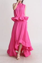 Woman in a bright pink two-piece set, showing the tiered ruffles on the skirt.