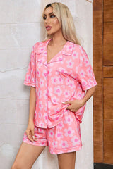 Close-up of a woman in a pink floral print pajama set, showing the button-down top.