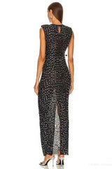 Back view of a black sequined dress with a keyhole back and a high slit