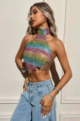 Side view of a woman modeling a shimmering rainbow halter top.