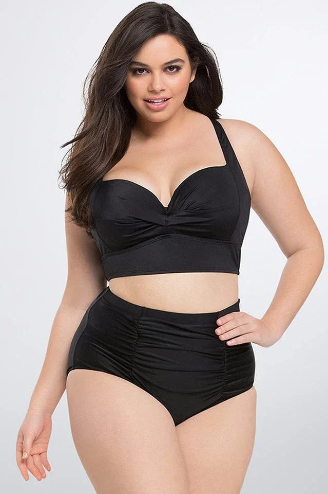 Plus-size model wearing a black high-waisted bikini with a sweetheart neckline top