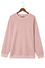 Pink ribbed long-sleeve oversized tunic hanging on a wooden hanger