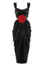 Full view of a black sequined gown with a sweetheart neckline, cut-out waist, and draped skirt.