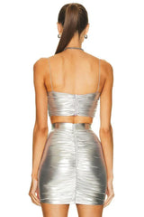 Back view of a woman wearing a silver metallic ruched bustier top and matching ruched mini skirt.