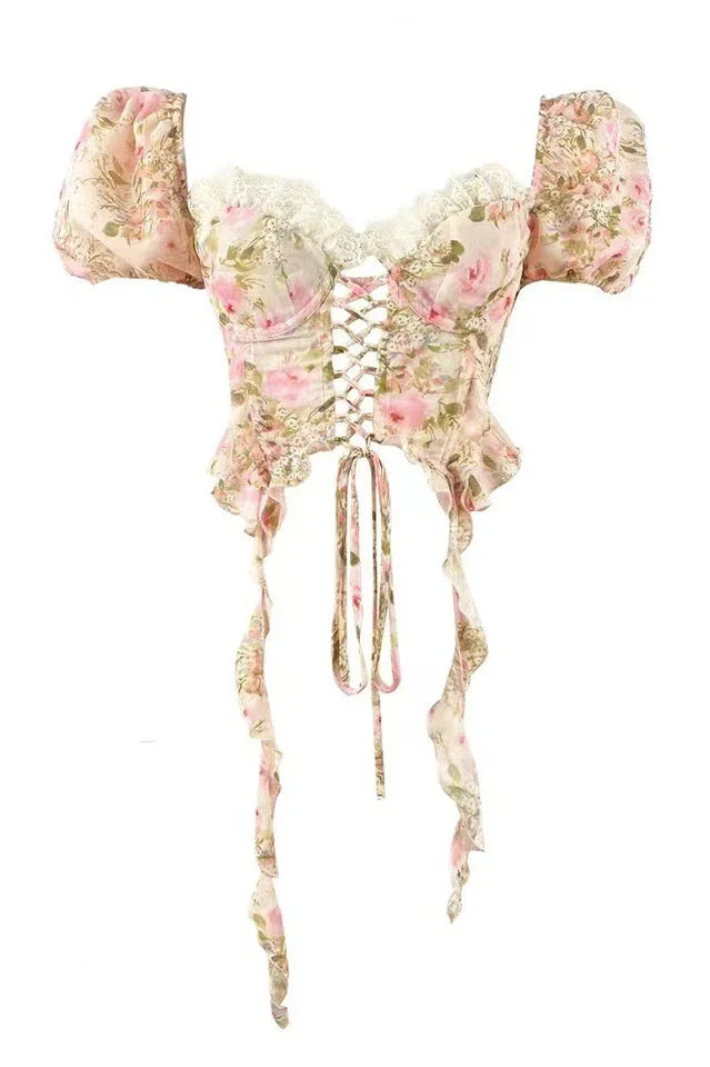 Product image of a floral print corset top with puffy sleeves, lace trim, and a lace-up front.