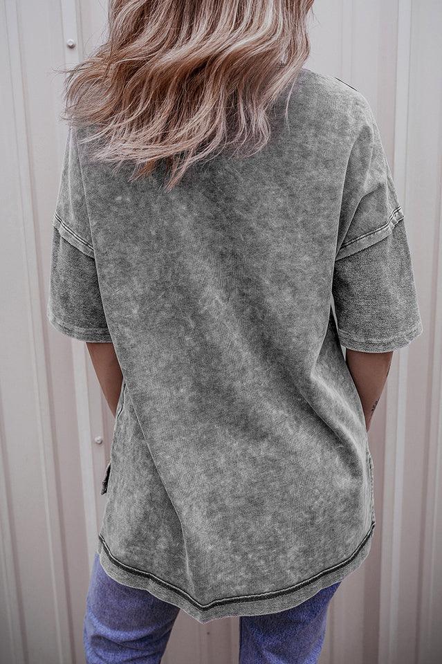 Back view of a woman wearing a grey acid wash oversized t-shirt