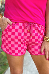 Close-up of pink checkerboard shorts with drawstring