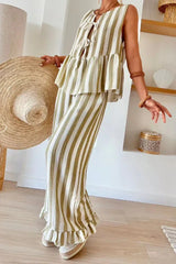 Woman showcasing a green and white striped linen blend matching set with a tie-front top and ruffled hem pants.