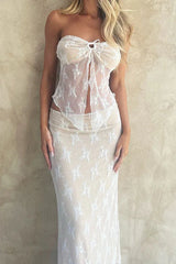 Close-up of a woman in a white lace top and skirt set