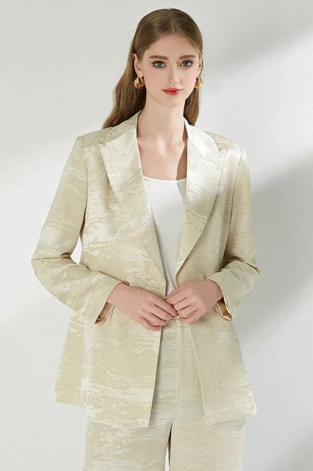 Close-up of the woman's cream jacquard blazer.