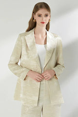 Close-up of the woman's cream jacquard blazer.