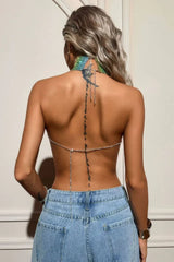 Back view of a woman showcasing the open back and chain detail of a rainbow halter top.