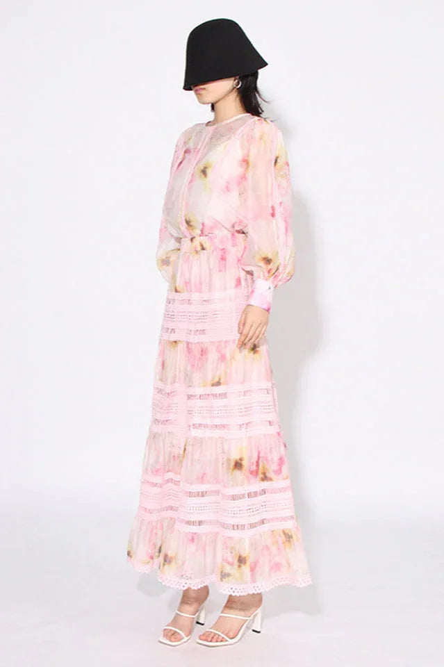 Woman wearing a pink floral print maxi dress from the side