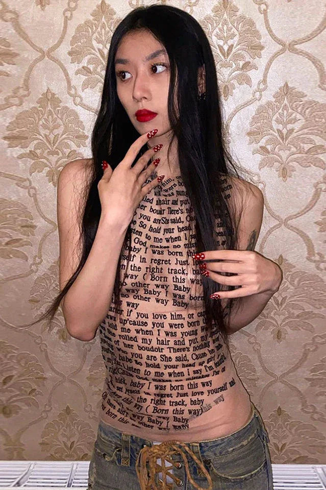 Woman in a black top with text print and red nails.