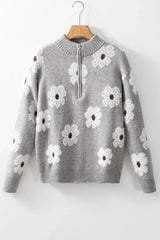 A gray floral print quarter-zip knit sweater with a mock neck, long sleeves, and ribbed cuffs and hem, displayed on a hanger.