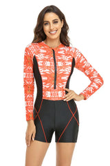 Woman wearing an orange tie-dye long-sleeve one-piece swimsuit with shorts
