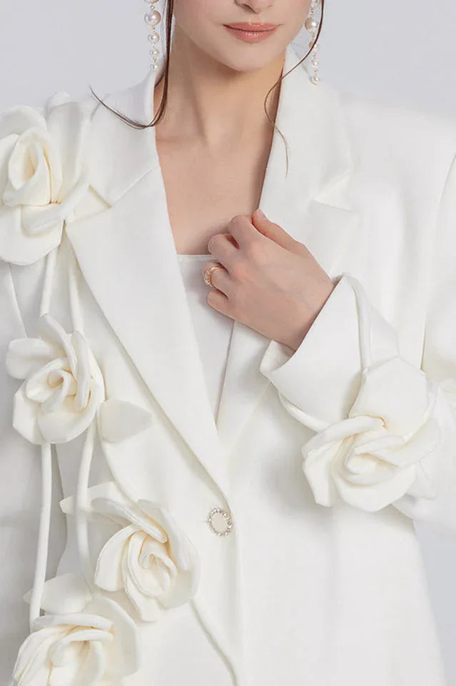 Close-up of the floral embellishments on a white blazer dress