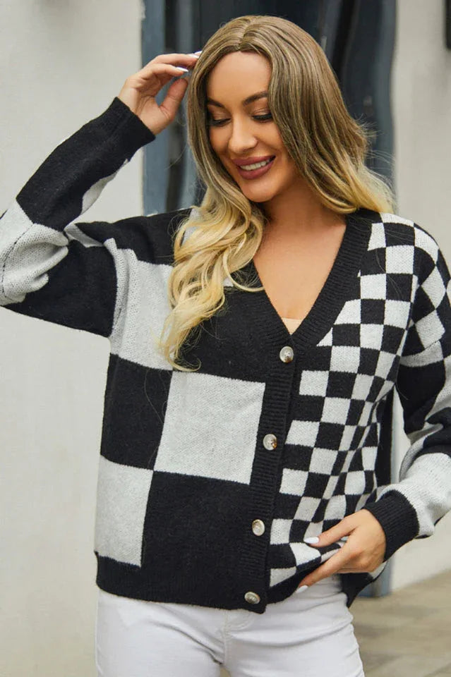 Close-up of a woman wearing a black and white checkerboard print cropped cardigan.