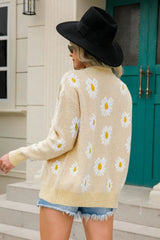 Back view of a woman wearing a beige daisy print knit cardigan