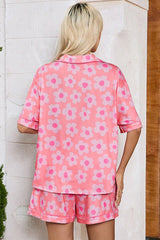 Back view of a woman wearing a pink floral print pajama set.