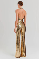 Woman wearing a gold sequined halter neck jumpsuit with wide leg pants, back view.