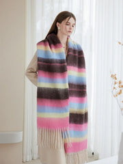 Full body shot of a woman wearing a colorful striped scarf and a beige coat, with the scarf draped down.