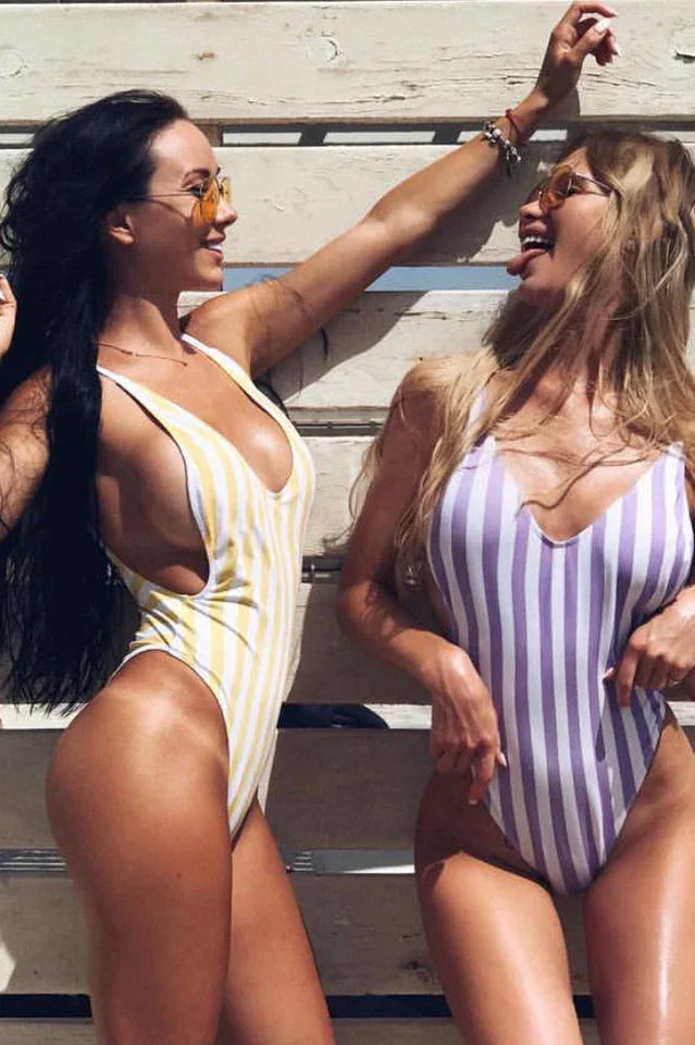 Two women in striped one-piece swimsuits