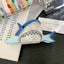 Blue novelty shark acetate hair claw clip with pearlescent white belly and open mouth detail - View 6 | TEVQA
