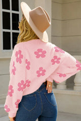 Back view of a woman wearing a pink fluffy knit cropped cardigan with a floral print.