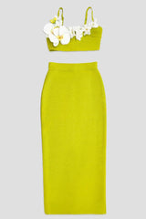 Lime green crop top with floral embellishments and a matching midi skirt, displayed separately.