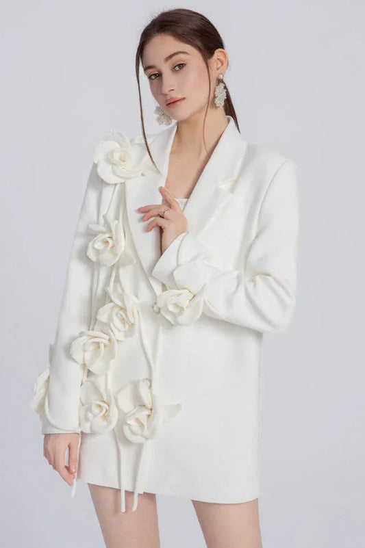 Woman wearing a white blazer dress with 3D floral embellishments