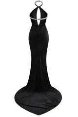 Back view of a black velvet mermaid gown with a low back and long train.