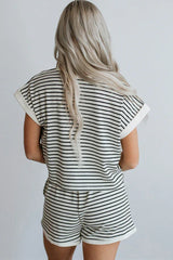 Woman wearing a black and white striped loungewear set, back view