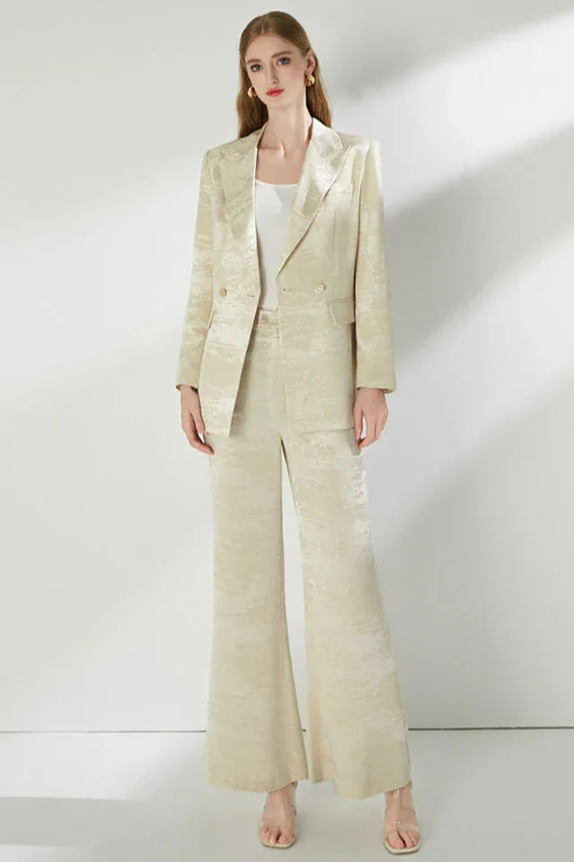 Front view of a woman in a cream jacquard suit.