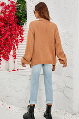 Back view of a woman wearing a brown floral cardigan and light wash ripped jeans.