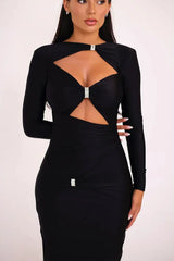 Close-up of the bodice of a black long-sleeved maxi dress, showing the keyhole and cut-out details.