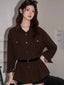 Woman wearing a brown corduroy shirt dress with a black belt