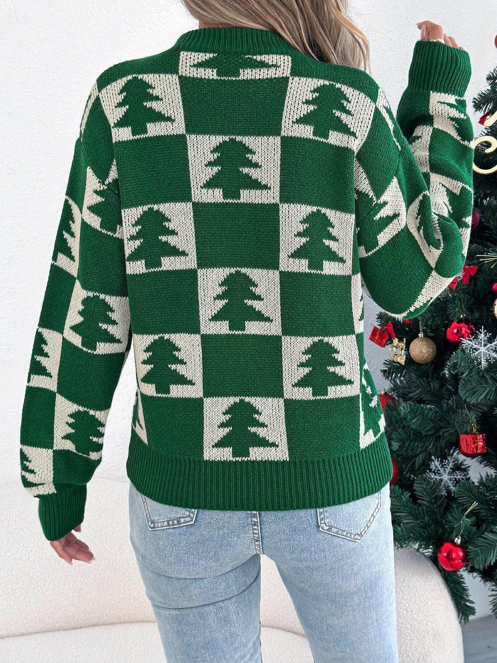 Back view of a woman in a green and white checkered Christmas tree sweater