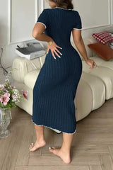 Back view of a woman wearing a navy blue ribbed knit midi dress with white contrast trim.