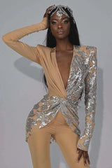 Elegant woman showcasing a high-fashion jumpsuit with a striking asymmetrical sequined design and wide-leg pants.