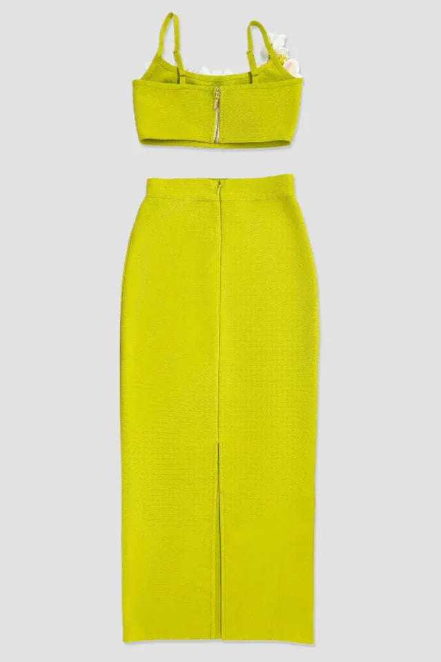 Back view of a lime green crop top with floral embellishments and a matching midi skirt, displayed separately.
