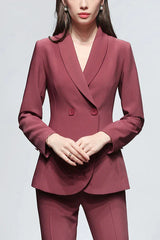 A woman poses in a stylish red pantsuit, demonstrating the sophisticated cut and fit.