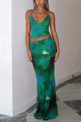 Woman wearing a green floral print crop top and matching maxi skirt