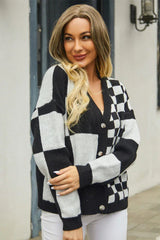 Woman in a black and white checkerboard print cropped cardigan, smiling.