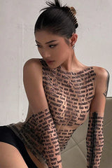 Woman in a sheer black top with text print, looking down.