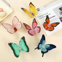 Assortment of butterfly hair claw clips in various colors: pink, yellow, orange, green, and blue