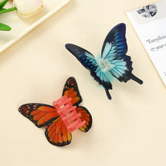 Close-up of blue and orange butterfly hair claw clips